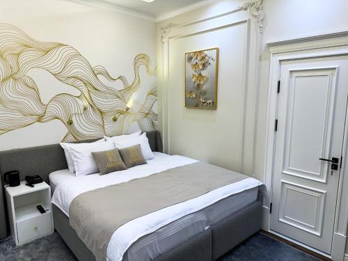 a bedroom with a bed with a large headboard at Qadim Hotel in Samarkand