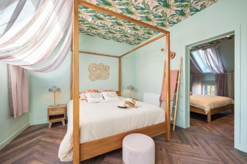 a bedroom with a canopy bed and a mirror at The Music Suites in Bruges