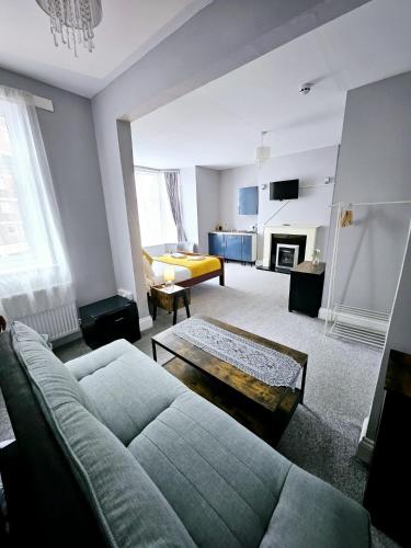 a living room with a couch and a fireplace at A-N-G Apartments - Parking EV 22kW by the Beach, Canoe Lake & South Parade Pier in Portsmouth
