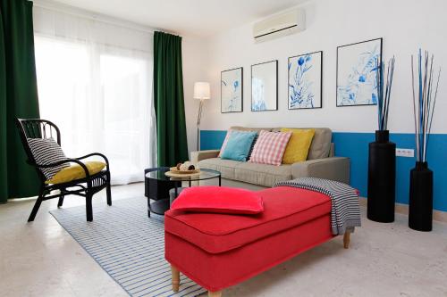 a living room with a couch and a red ottoman at Vacation Home Villa Oleandra in Bol