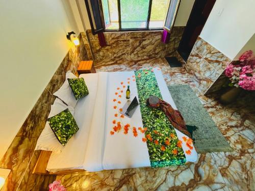 a table with a knife and flowers on it at Hotel Brownie River View in Kasol