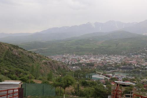 a view of a town in a valley with mountains at Chorvoq View in Chorwoq