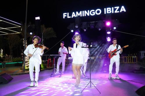 a group of people on a stage playing music at Flamingo Hai Tien in Nam Khê
