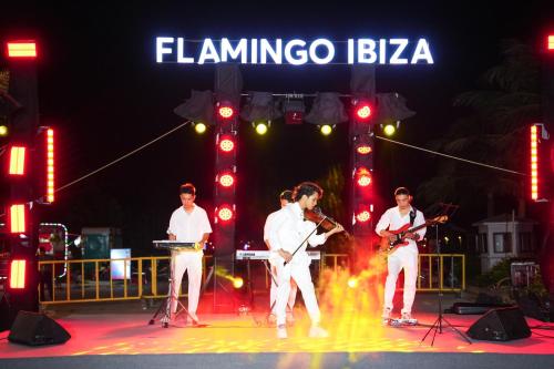 a group of men playing music on a stage at Flamingo Hai Tien in Nam Khê