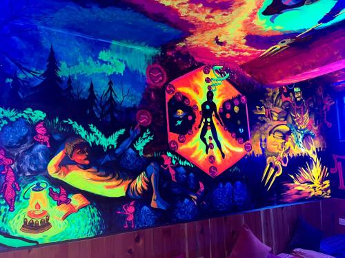 a room with a wall decorated with colorful lights at Hotel Brownie River View in Kasol