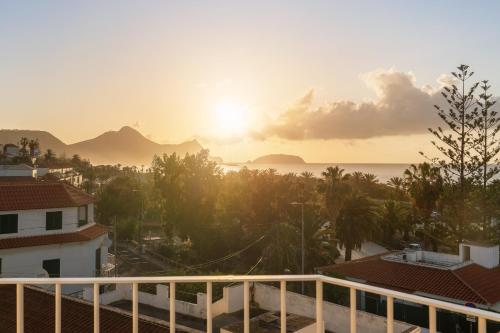 a view of the sunset from the balcony of a building at Fontinha by An Island Apart in Porto Santo