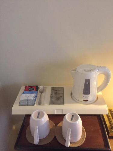a shelf with a blender and two bowls on it at Grand Bungalow Nuwara Eliya by Seven Angels in Nuwara Eliya