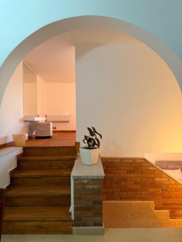 an archway over a staircase with a potted plant at Vila Dena in Vlorë