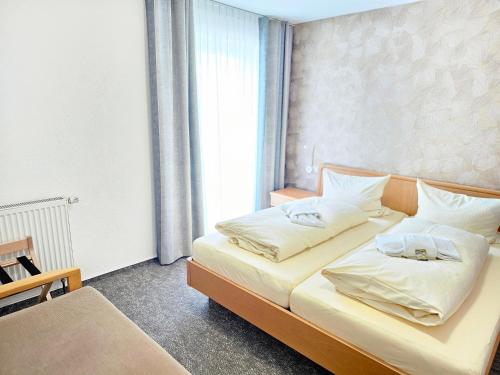 a bedroom with a bed with two pillows on it at Gasthof goldener Engel in Kemnath
