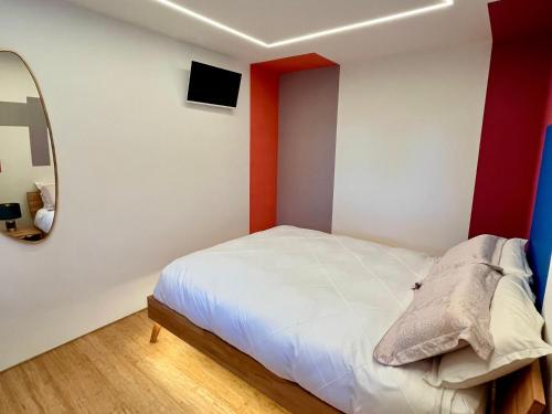 a bedroom with a white bed and a mirror at Luxurious guest house in Yorkshire with parking in Hemingbrough