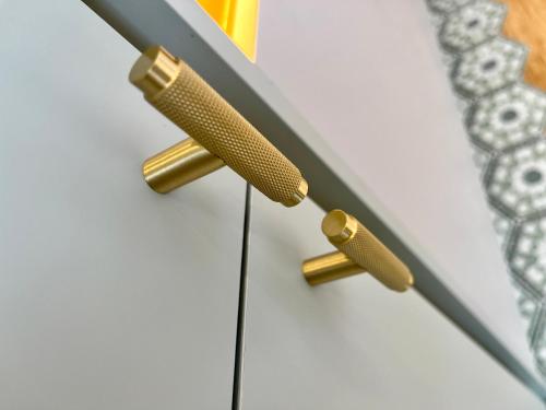 a pair of brass drawer pulls on a white cabinet at Luxurious guest house in Yorkshire with parking in Hemingbrough