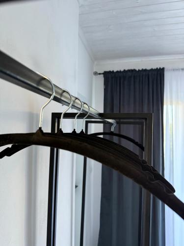 a black hanger in a room with a window at Shtëpia Me Lule in Përmet