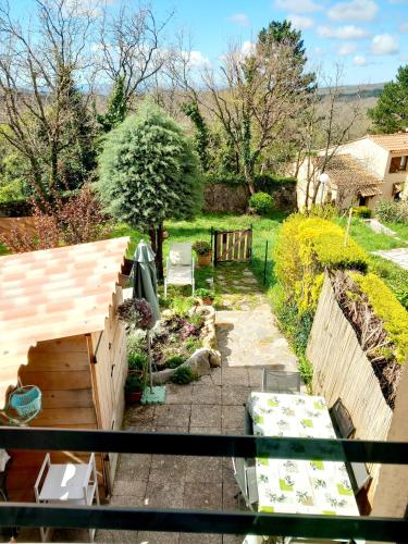 a view of a garden from the balcony of a house at Maisonnette au calme in Saint-Vallier-de-Thiey