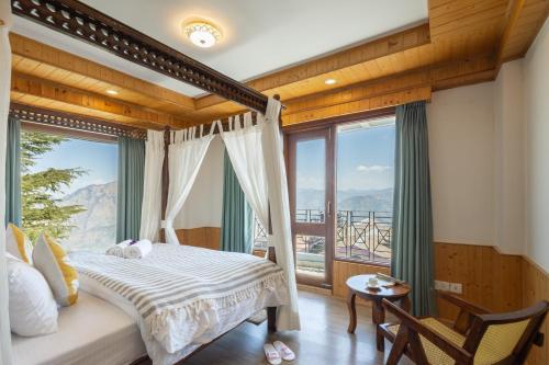 a bedroom with a bed and a large window at Hostie Heaven View - 3BHK Duplex with Terrace, Mashobra in Mashobra