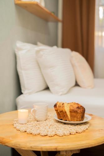 a table with a plate of bread and two cups at Ideal house for families, large groups & cozy in Santa Rosa de Copán