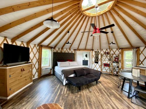 a bedroom in a yurt with a bed and a ceiling at Serenity Yurt in Sunny View