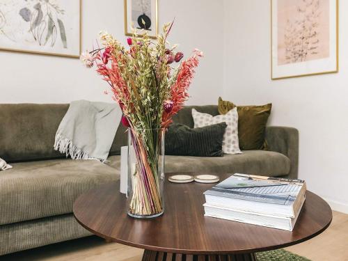 a vase of flowers on a table in a living room at 4 star holiday home in Vedbæk in Vedbæk