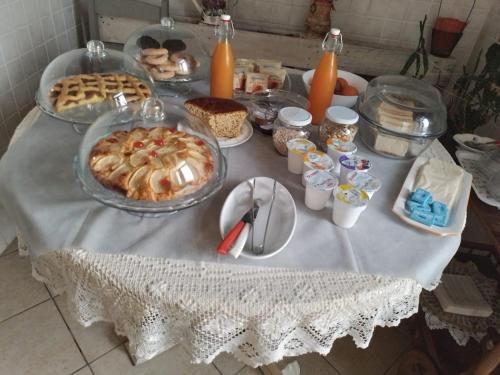 a table with a white table cloth with food on it at Castelvecchio B&B in Sorano
