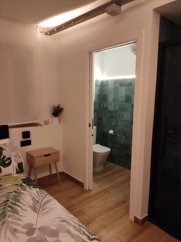 a bedroom with a bed and a bathroom with a toilet at El Pisito in Ontinyent