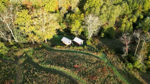 an overhead view of two barns in a forest at Off-Grid Cabin with Fire Pit and Trail Access Nestled in Nature in Sugar Grove, West Virginia in Sugar Grove