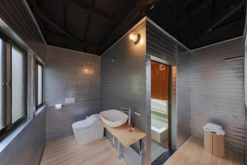 a bathroom with a toilet and a sink at OKANiWA 丘庭 in Nagiso