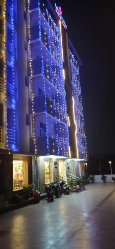 a large building with blue lights on it at night at Hotel Girija Sunrise 300 Meter from Baba Dham Temple in Deoghar
