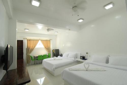 Postel nebo postele na pokoji v ubytování Coron Bluewave Hotel