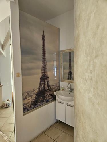 a bathroom with a picture of the eiffel tower at Villa Farage in Mielno