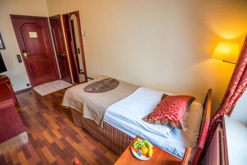 Postel nebo postele na pokoji v ubytování Hotel Astor