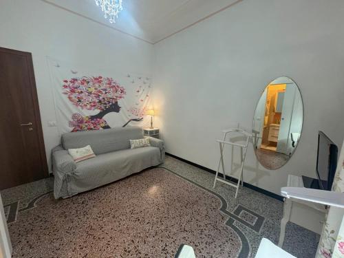 a living room with a couch and a mirror at Luxury Penthouse 50m from the Sea, near the Center in Savona