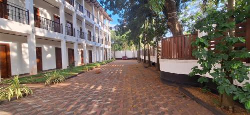 a cobblestone street in front of a building at Safari Eye Hotel - Thissa in Debarawewa