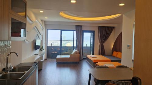 a kitchen and living room with a couch and a sink at Flc Sea Tower - ChillNow Căn hộ nghỉ dưỡng Quy Nhơn in Quy Nhon