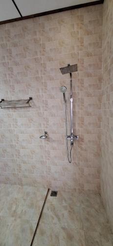 a shower in a bathroom with a stone wall at Safari Eye Hotel - Thissa in Debarawewa