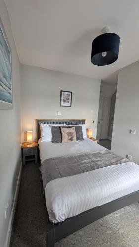 a bedroom with a large bed and two lamps at Coolin View in Portree