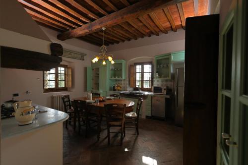 a kitchen with a table and chairs in a room at Palagina la dimora in Figline Valdarno