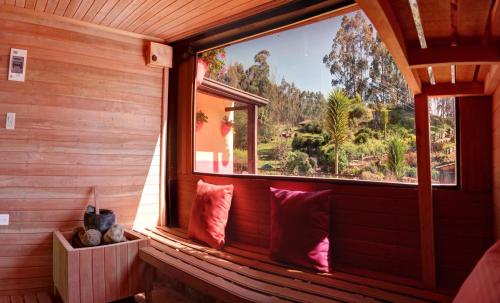 a window in a room with red pillows at Finca La Tobita Eco Hotel in Toca
