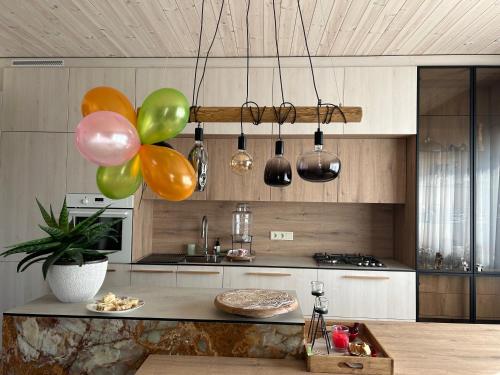 a kitchen with a bunch of balloons hanging from the ceiling at Jora prabangūs dviejų kambarių apartamentai in Stančiai