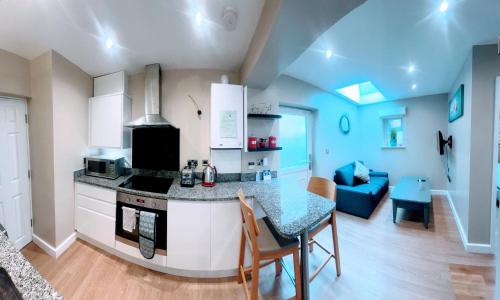 a kitchen with a counter and a table in a room at Valley Mount House & Apartment in Harrogate
