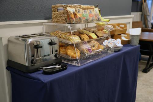 a table topped with a blue table cloth with pastries at Harbor Winds Hotel in Sheboygan