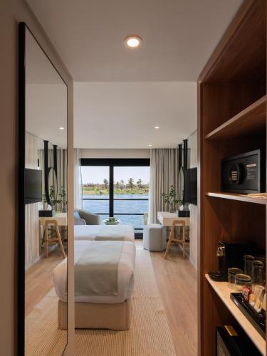 a bedroom with a bed and a living room at Soleil Nile Cruise - Every Monday from Luxor for 4 & 7 Nights, and every Friday from Aswan for 3 & 7 Nights in Luxor