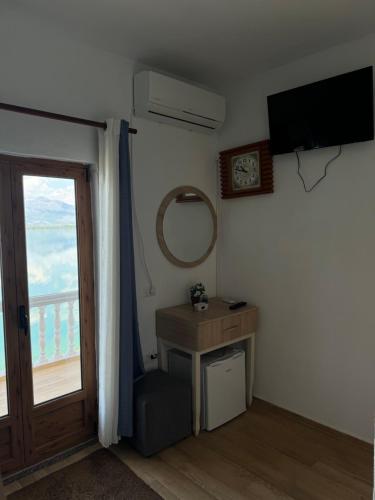 a room with a window and a television and a door at Bella Vista in Shkodër