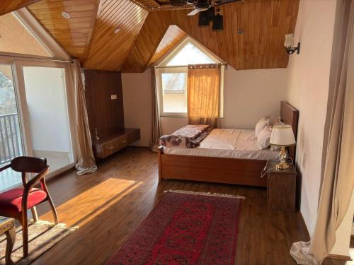a bedroom with a bed and a large window at Tropical Green in Srinagar