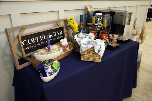 a blue table with a coffee and bar sign on it at Harbor Winds Hotel in Sheboygan