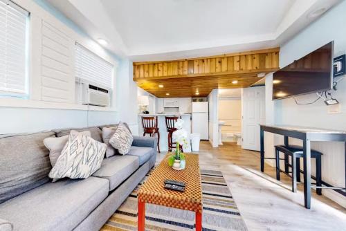 a living room with a couch and a table at Charmayne's Cottages - Truman @ Duval in Key West