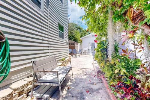 a patio with a bench next to a building at Charmayne's Cottages - Truman @ Duval in Key West
