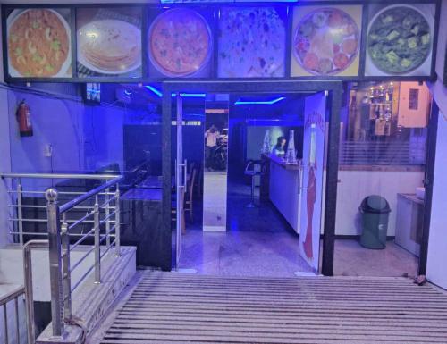 a restaurant hallway with stairs and plates on the wall at Hotel Neelam Bar & Restaurant in Sheoganj