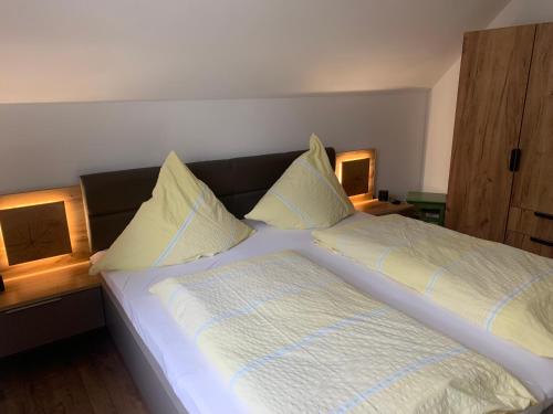 a bedroom with a bed with two lamps on it at Ferienhaus Lönartz-Thielmann in Ernst