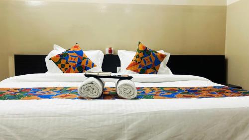 a hotel room with a bed with a tray on it at Hotel Comfort Inn in Jaipur