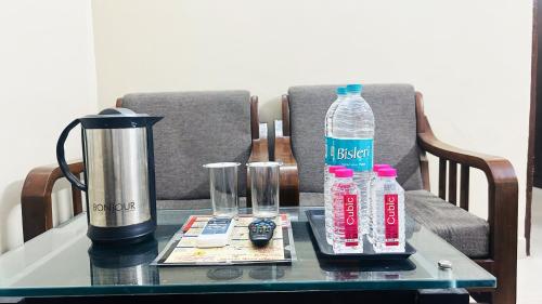 a table with bottles of water and a blender at Hotel Comfort Inn in Jaipur