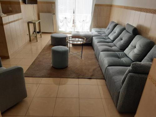 a living room with a couch and a table at La Maison de Cristina Michael in Blois